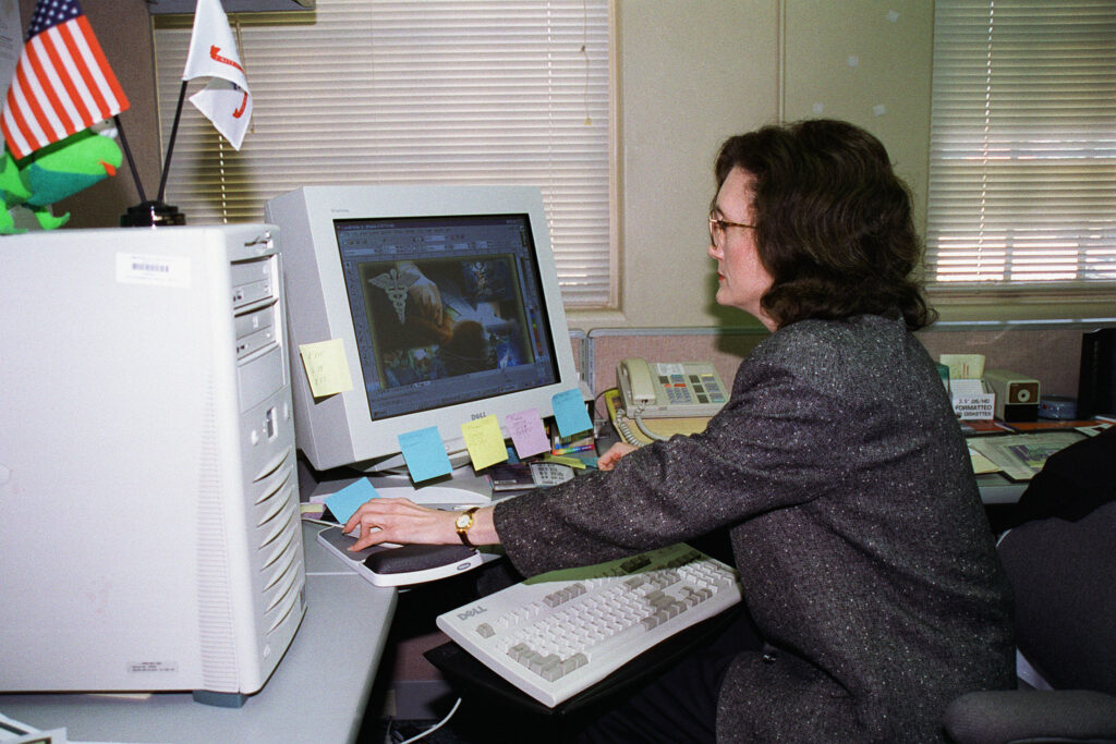 A woman uses graphics editing software on a computer